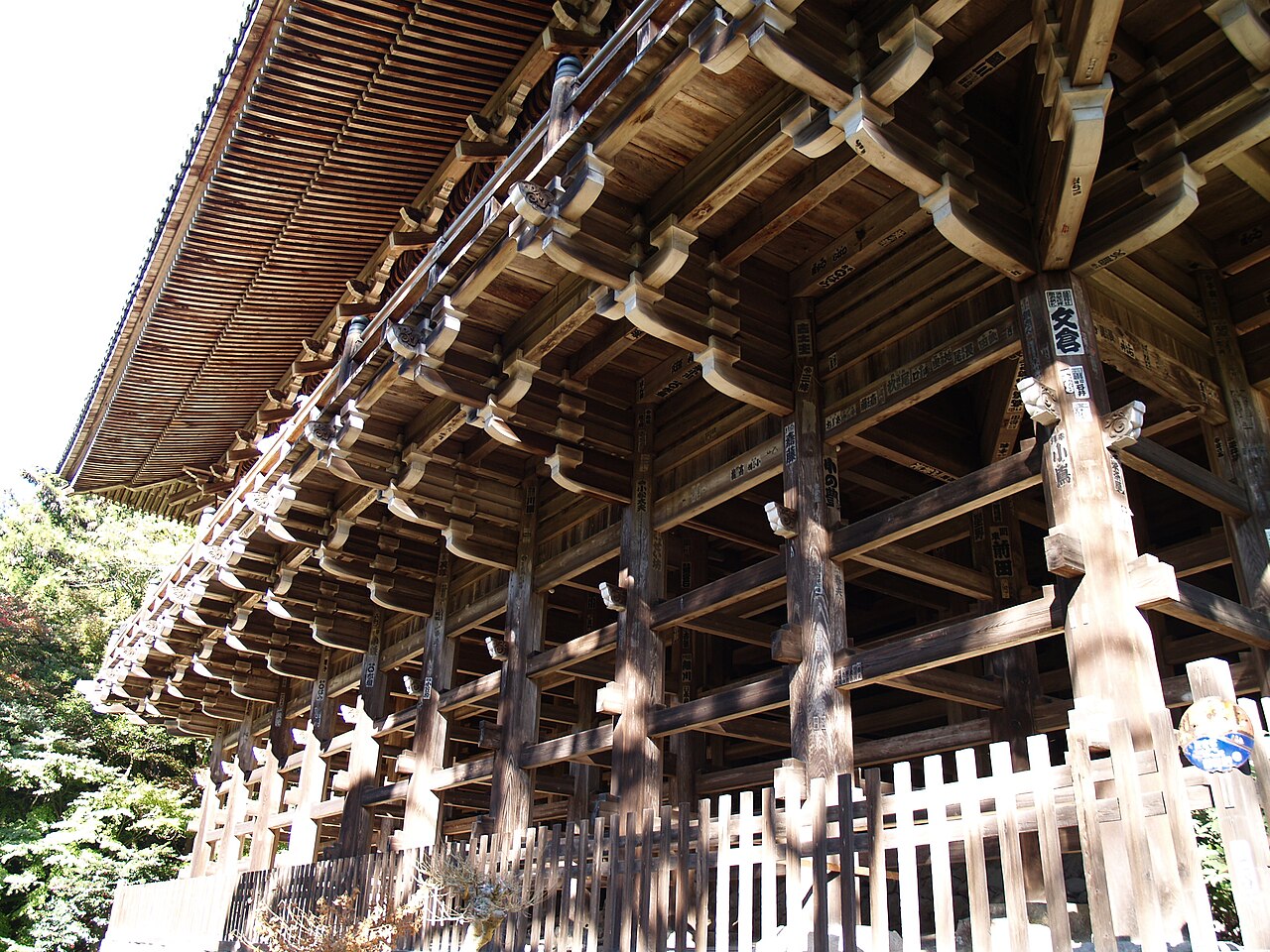 The stilted timber substructure of Engyo-ji's Maniden hall on Mount Shosha, its brackets and posts rising from the slope.