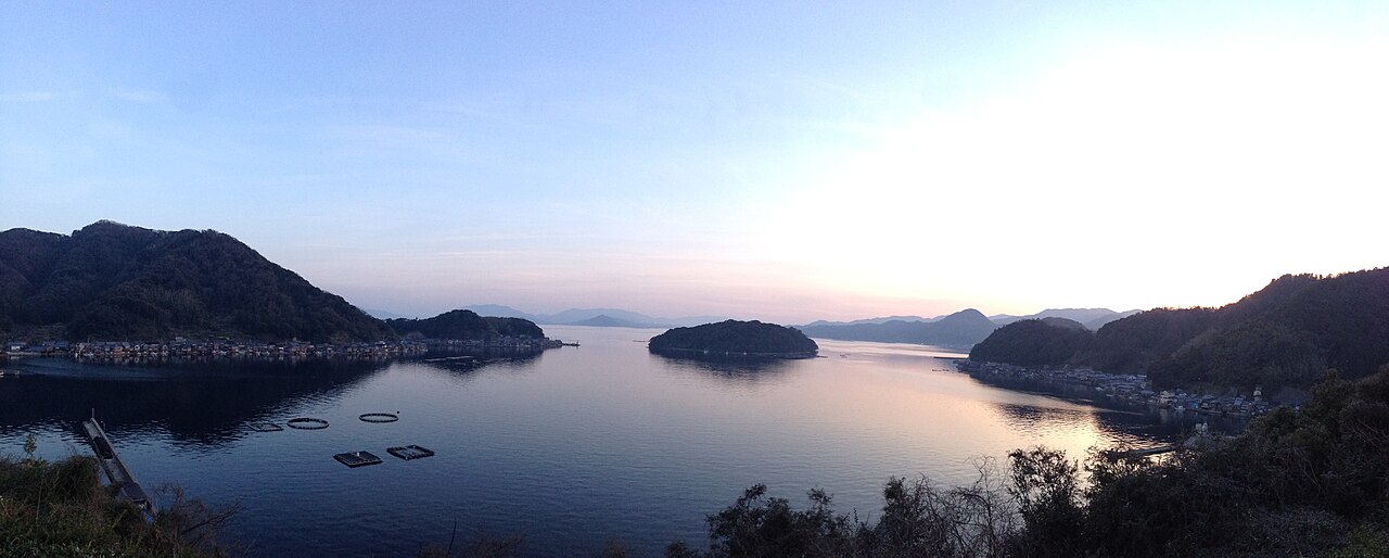 Ine Bay at dusk seen from the hillside, with the island of Aoshima in the middle of the water.