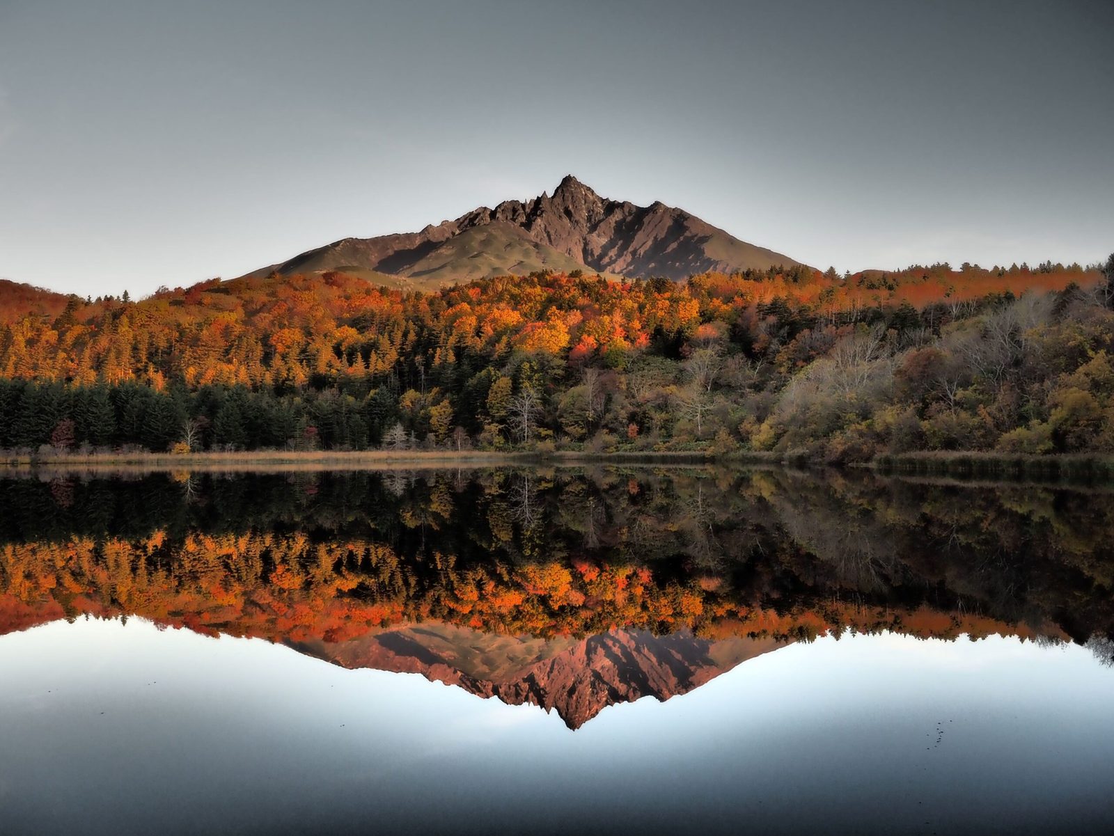 Mount Rishiri and autumn foliage reflected in Otatomari Pond