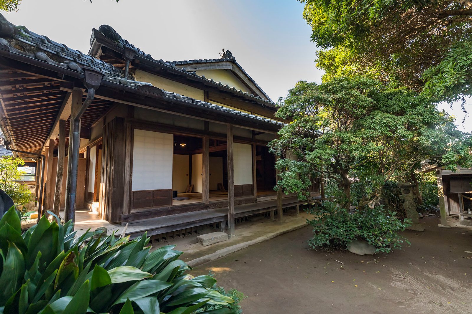 A samurai house with deep tiled eaves and a veranda facing its garden in Izumi Fumoto