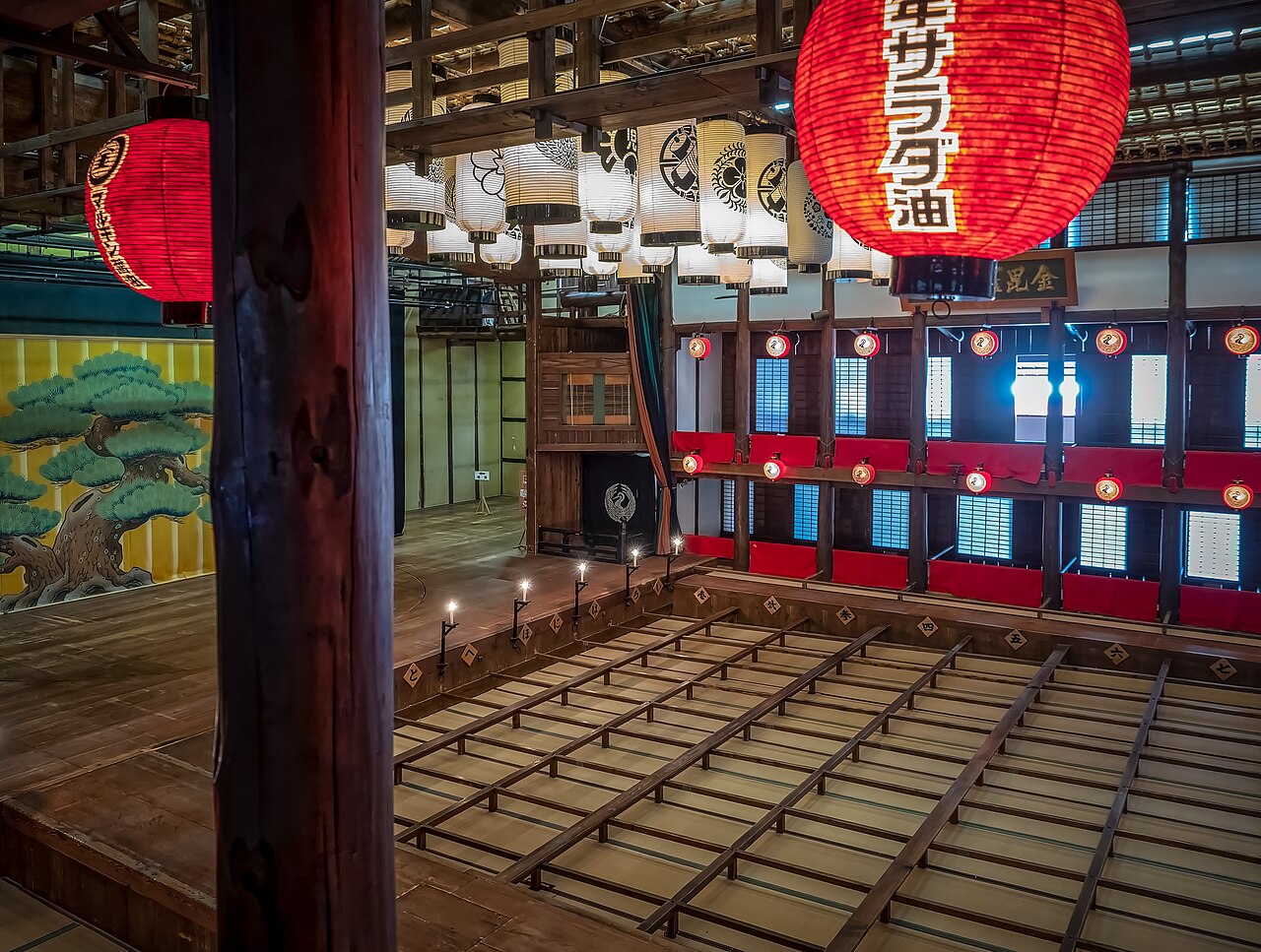 Inside Kanamaruza, the old kabuki playhouse in Kotohira, with rows of hanging lanterns above the boxed floor seating.