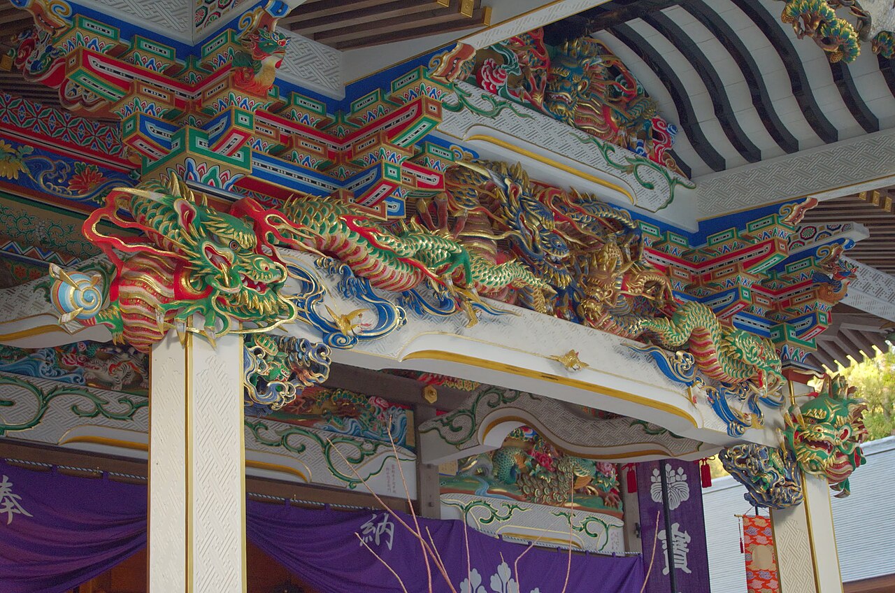 Brightly painted dragon carvings under the eaves of Hodosan Shrine at the foot of Mount Hodo.