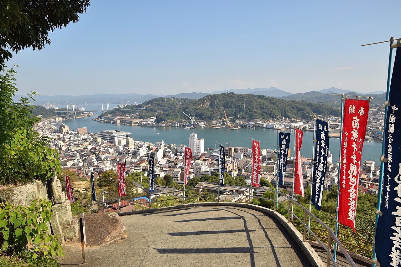 The channel at Onomichi seen from the hillside, with the long bridge to the island opposite and the roofs of the town below.
