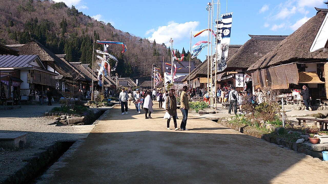 Carp streamers fly above the thatched roofs of Ouchi-juku's main street in spring.