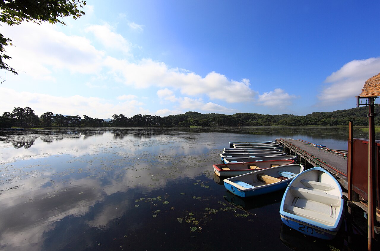 Rowing boats moored on the calm water of Nanko Pond in Shirakawa