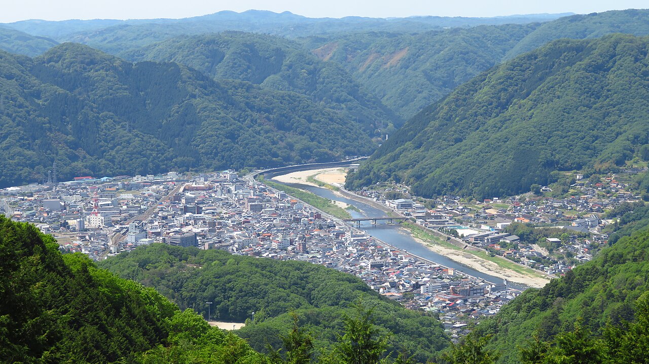 The town of Takahashi in a mountain valley along a river, seen from the cloud-sea viewpoint above Bitchu Matsuyama Castle