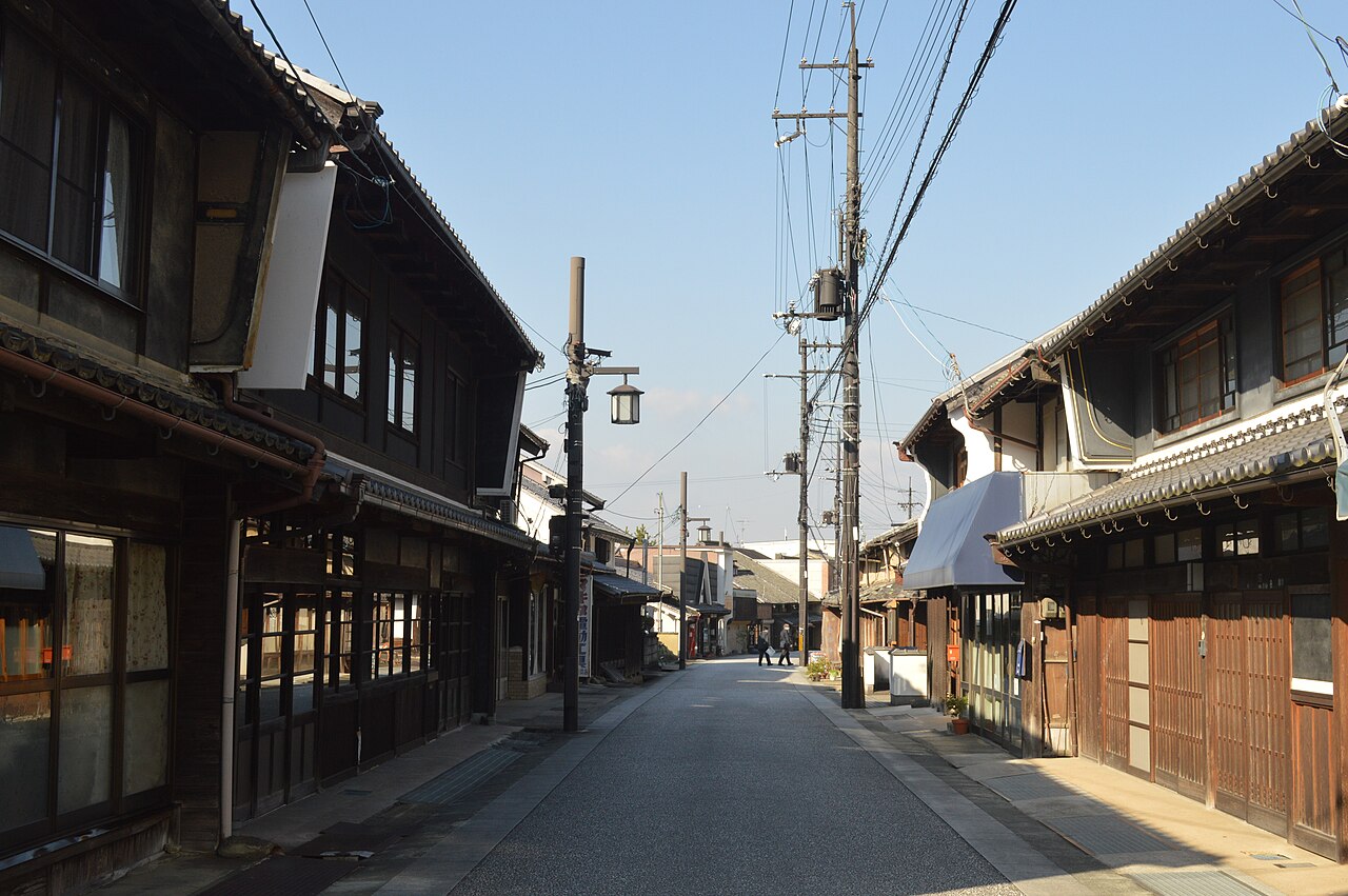 A quiet old-town street lined with dark timber merchant houses in Uda-Matsuyama