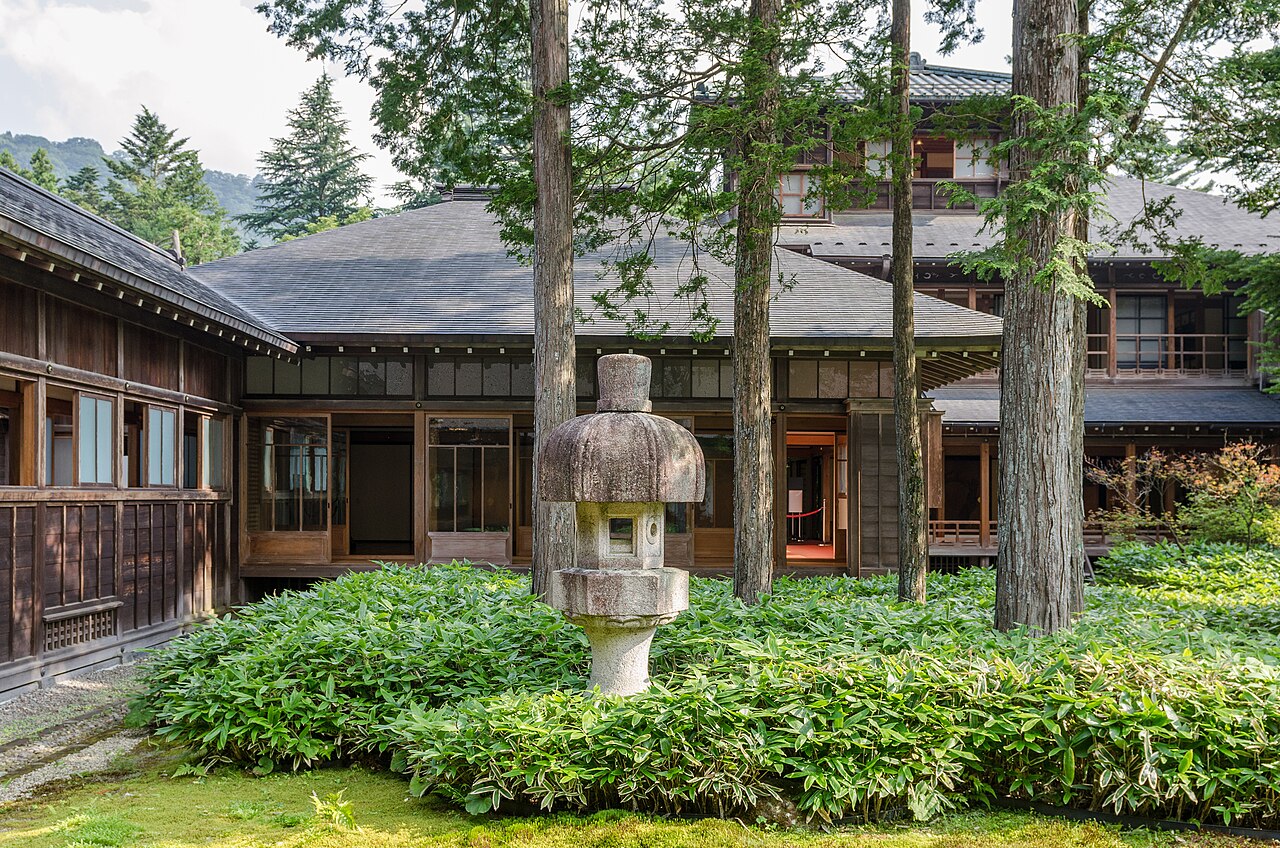 An inner courtyard garden at the Tamozawa Imperial Villa, framed by the surrounding wooden wings of the residence.