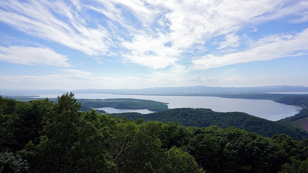 Lake beyond a forest seen from the viewpoint on Mount Tento