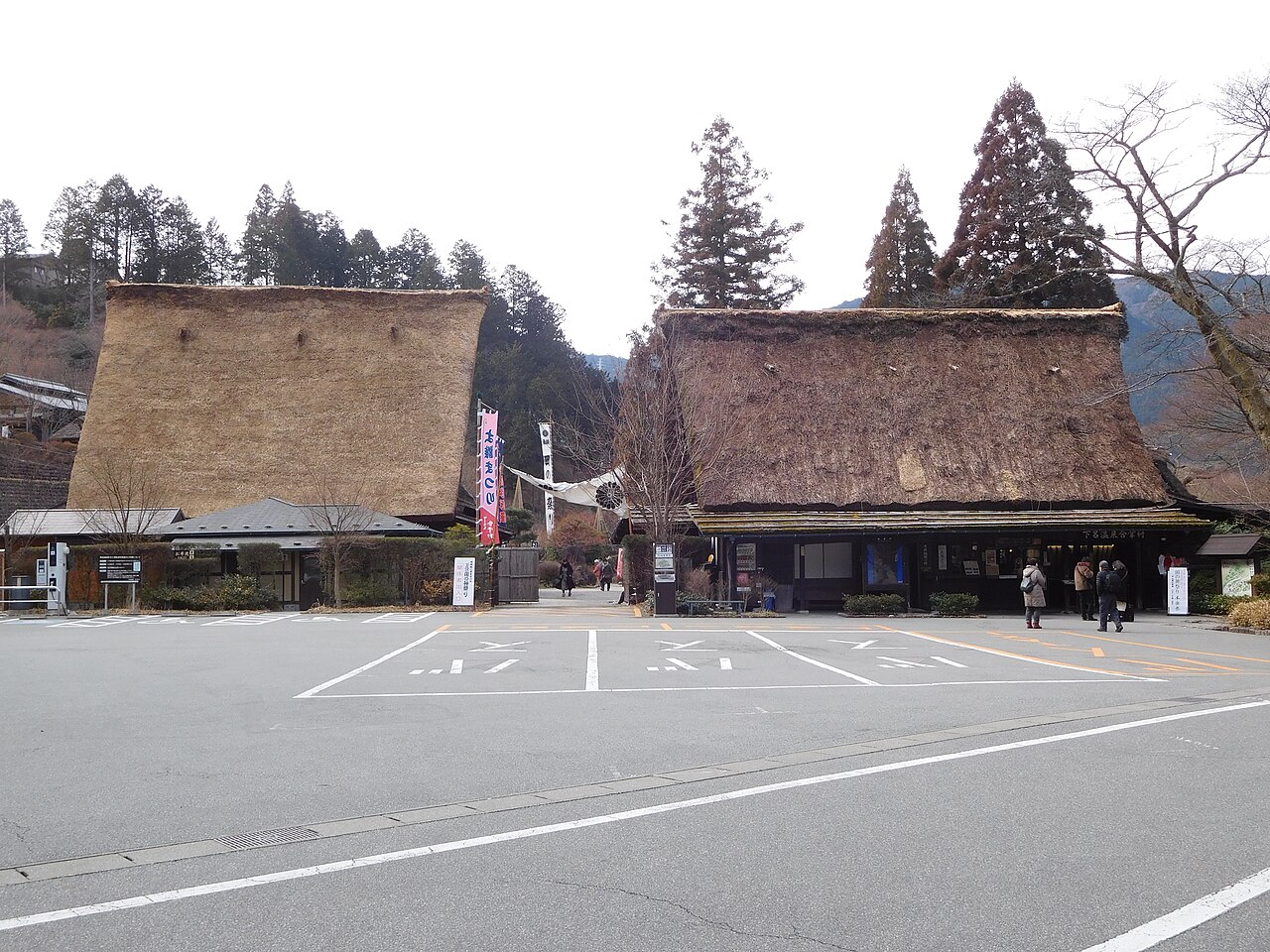 Two large thatched gassho-style farmhouses at the entrance of Gero Onsen Gassho-mura