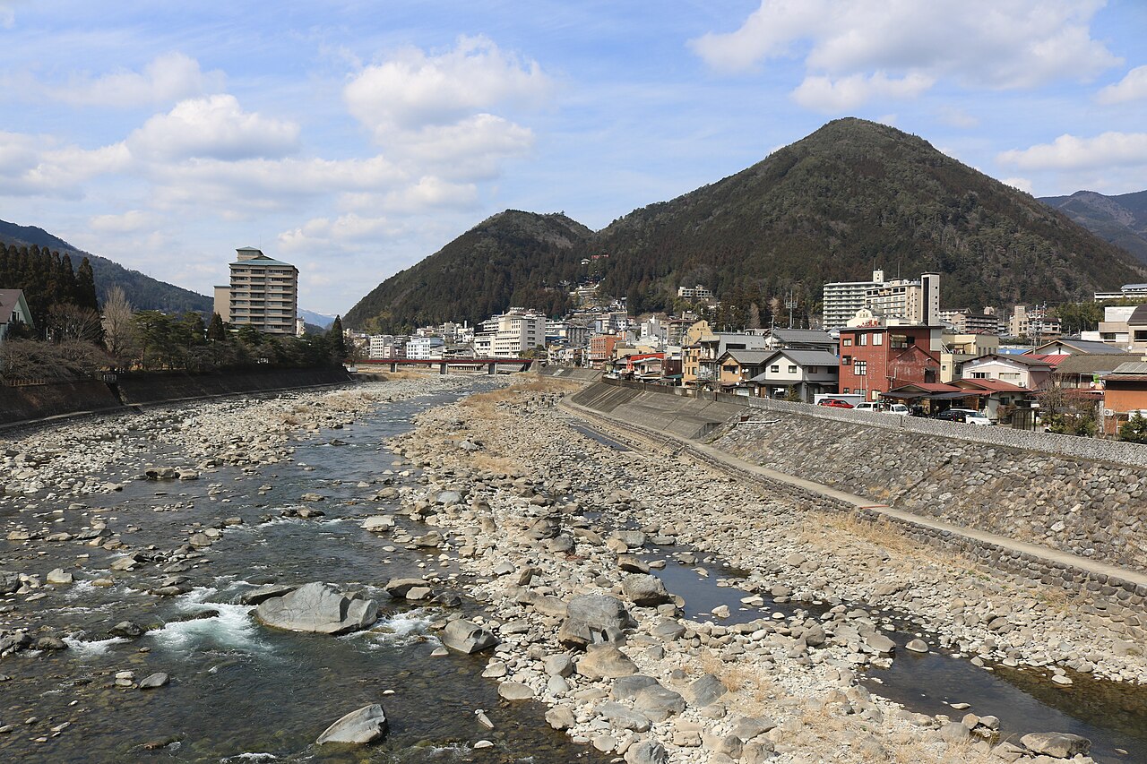 The rocky Hida River running past the hot spring town of Gero Onsen under green mountains