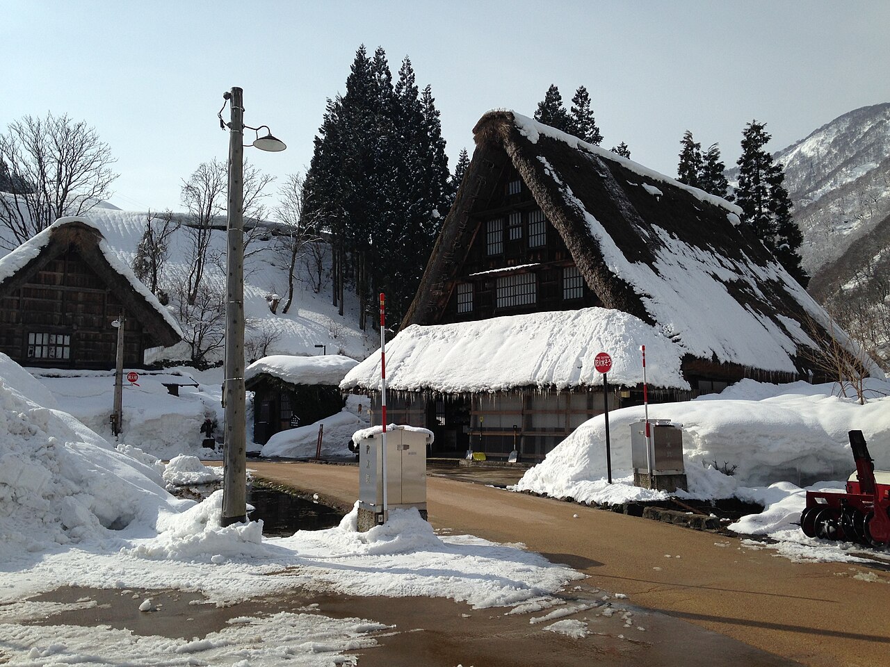Snow-covered lane through Suganuma village with thatched roofs on both sides