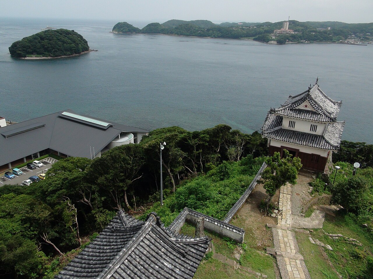 The Kensoyagura turret of Hirado Castle beside the sea, with islands in the distance