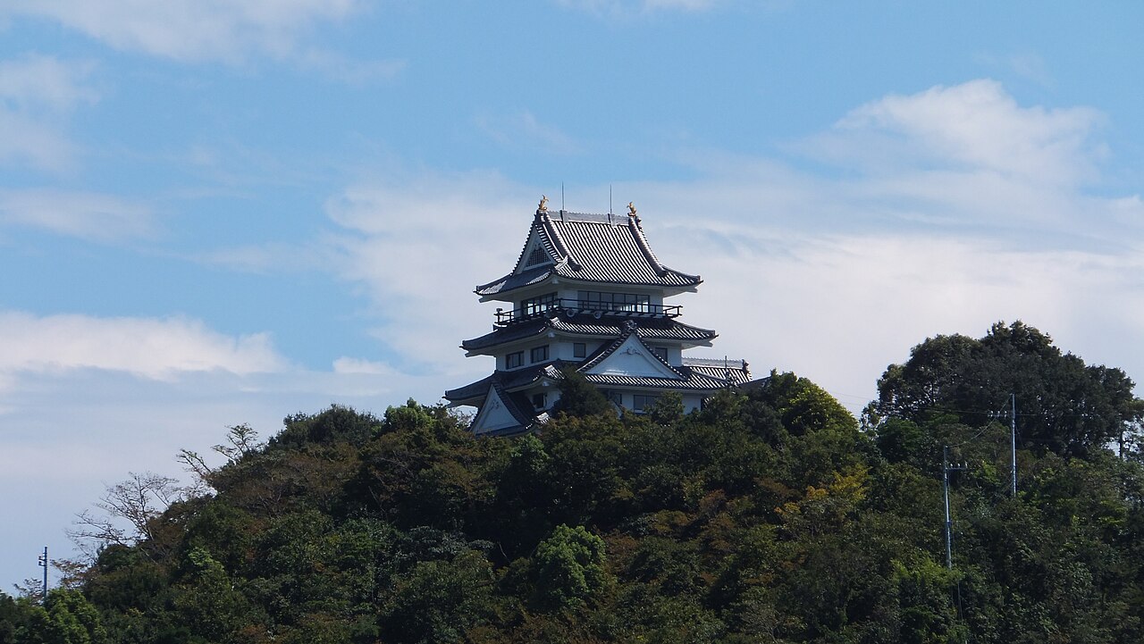 The keep-style building of Hiwasa Castle on a wooded hilltop