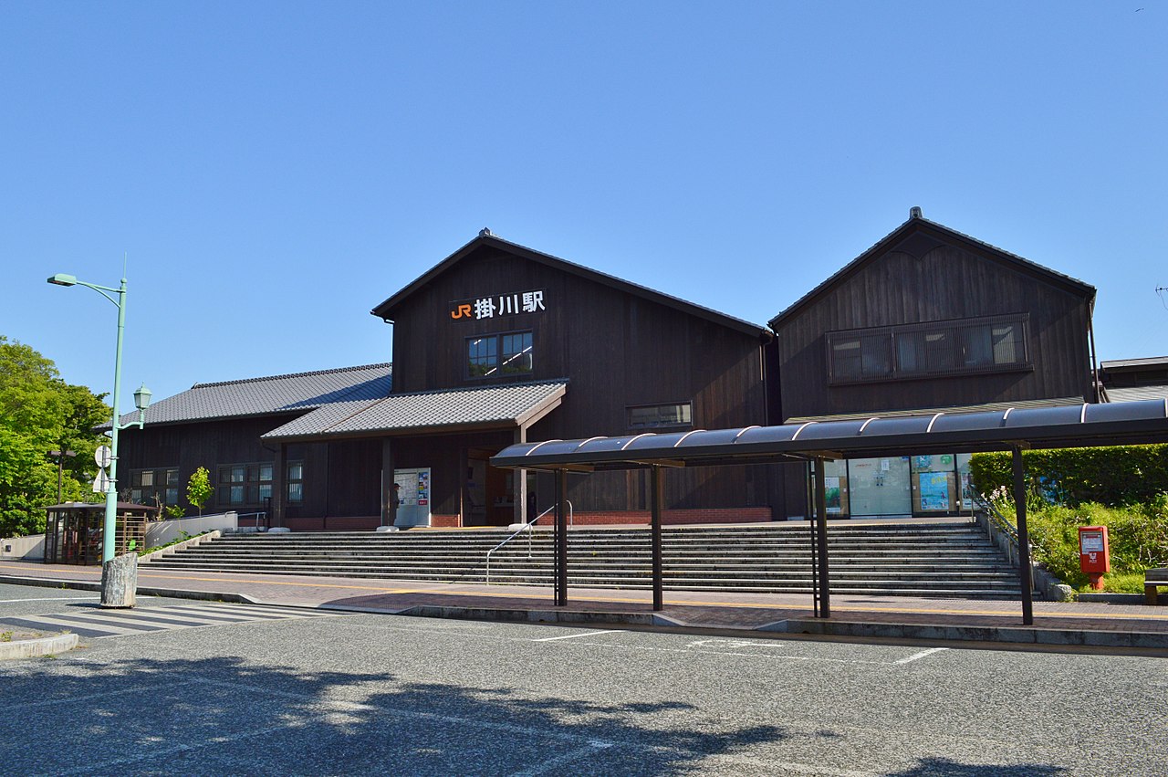 The dark wooden gabled building of JR Kakegawa Station with its wide stone steps