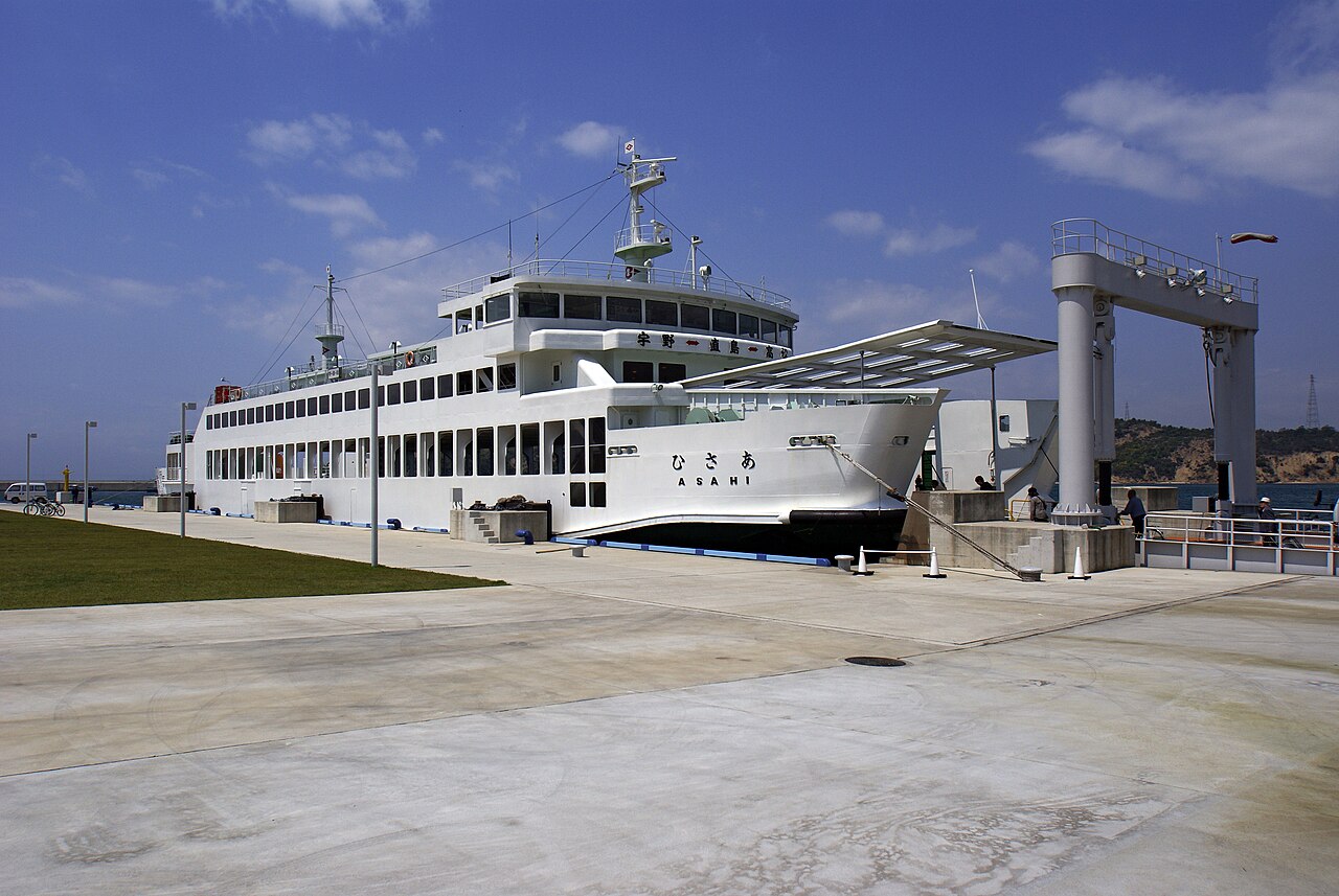 A white car ferry moored at Miyanoura port on Naoshima on a clear day