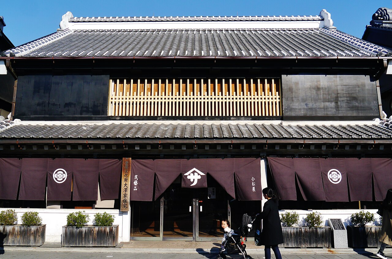 The dark tiled facade of the Osawa House, an Edo-period clay-walled merchant house on Kawagoe's warehouse street.