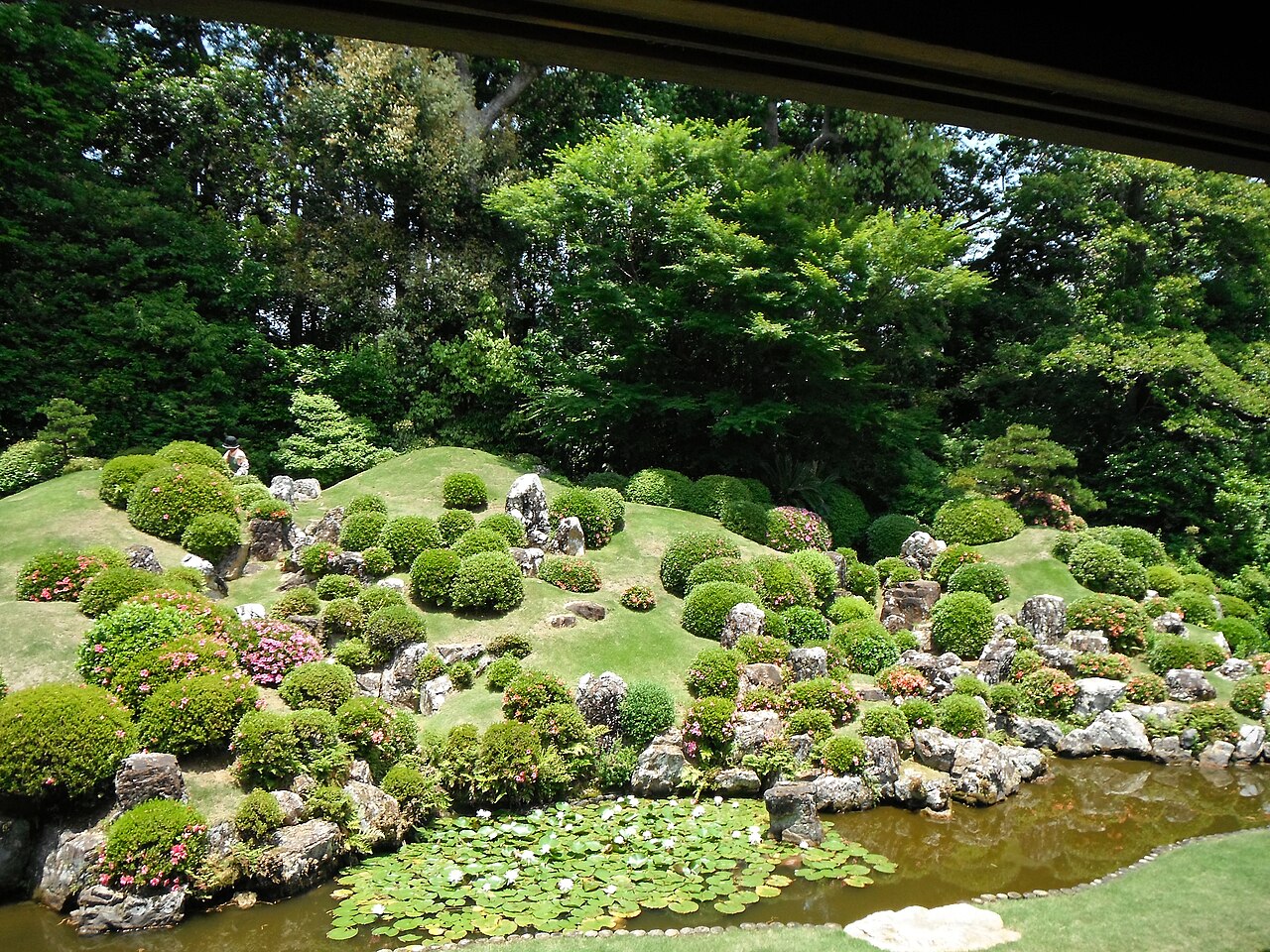 The moss-and-azalea mound garden with a pond and rock groupings seen from the veranda at Ryotanji Temple, Hamamatsu