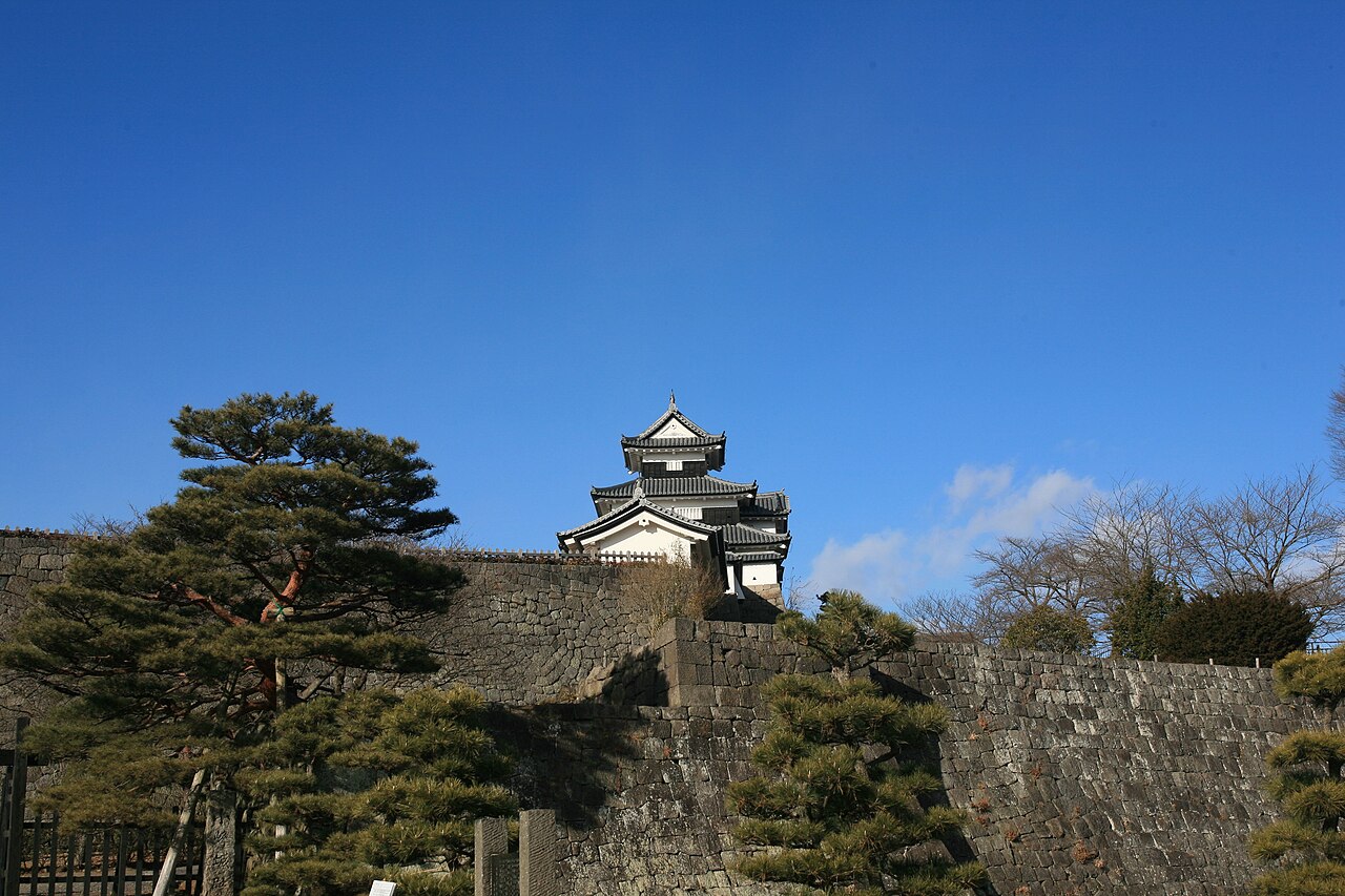Komine Castle's three-storey keep above stone walls in Shirakawa