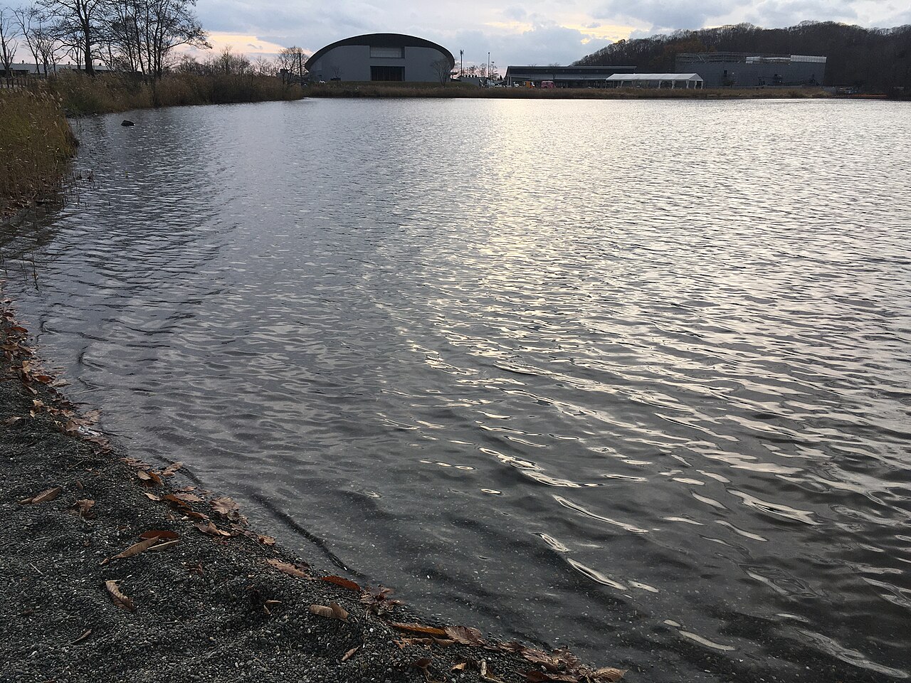 Lake Poroto's shoreline at Upopoy, with the museum building on the far bank
