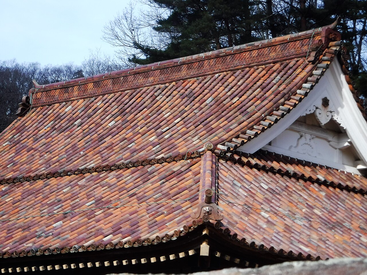 Close view of the reddish-brown glazed roof tiles on the Shizutani School lecture hall