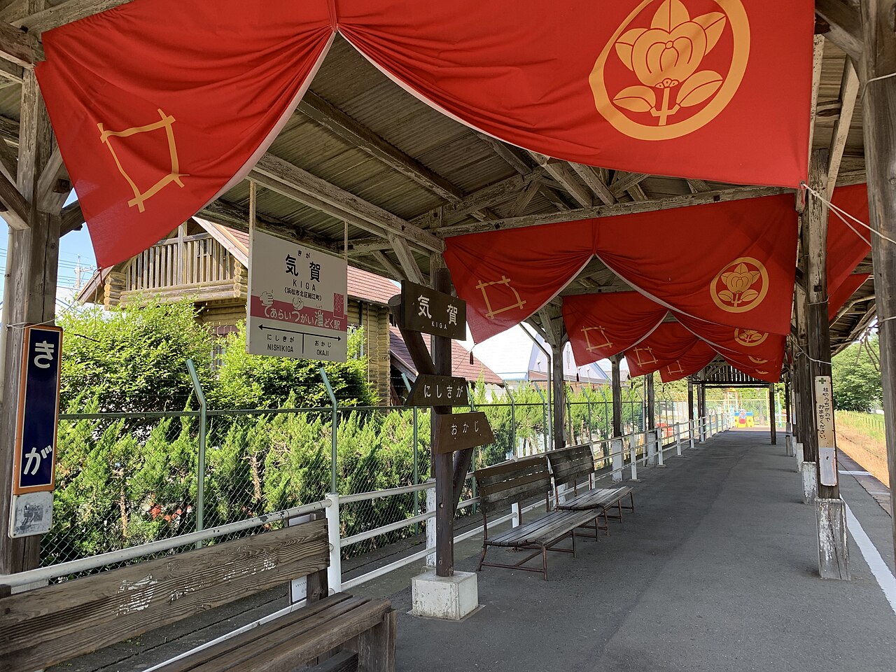 The covered platform of Kiga Station on the Tenryu Hamanako Railroad with red curtain decorations