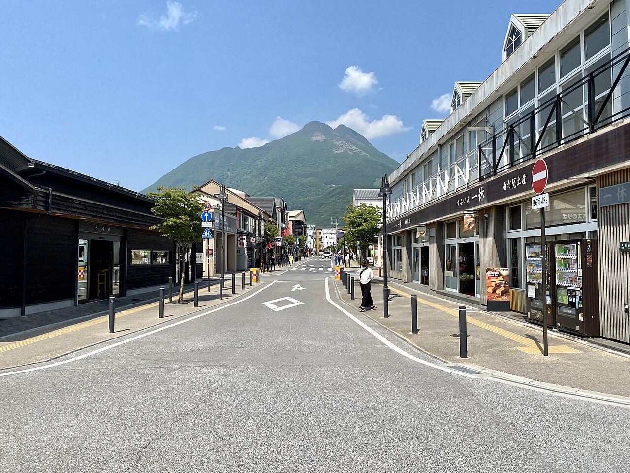Mount Yufu rising straight ahead at the end of the shop-lined street leading from Yufuin Station