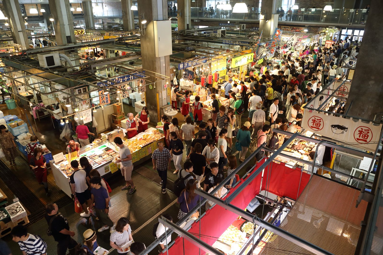 Crowds browsing sushi and seafood stalls on the floor of Karato Market